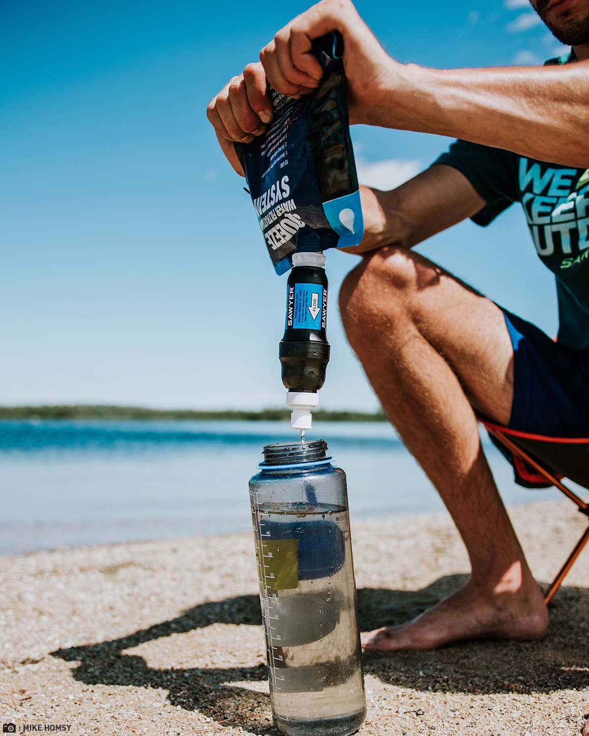 Demonstrating how to use a portable survival water filter